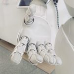 White picture of robot hand depicting AI.